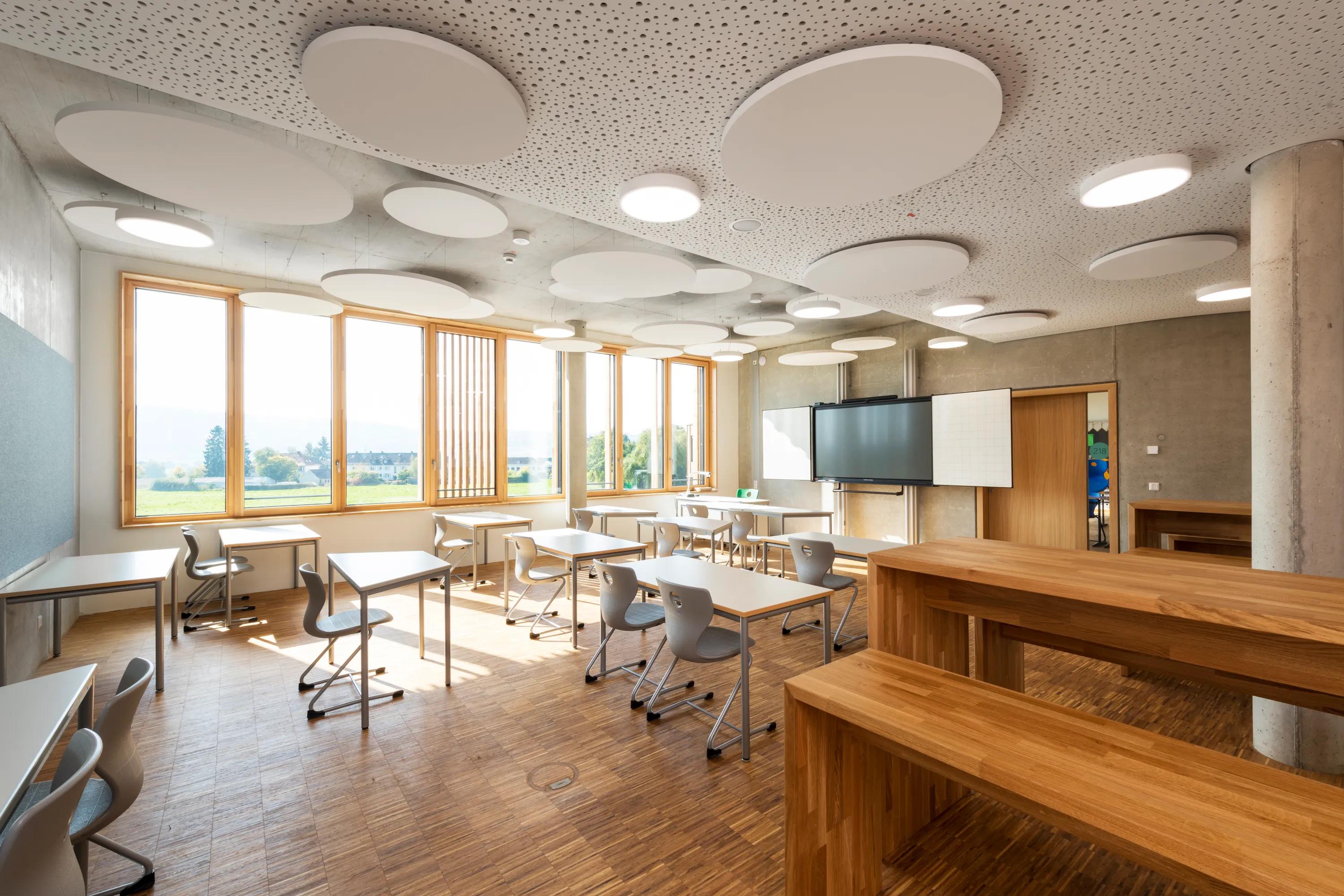 white ceiling with round suspended islands in a classroom