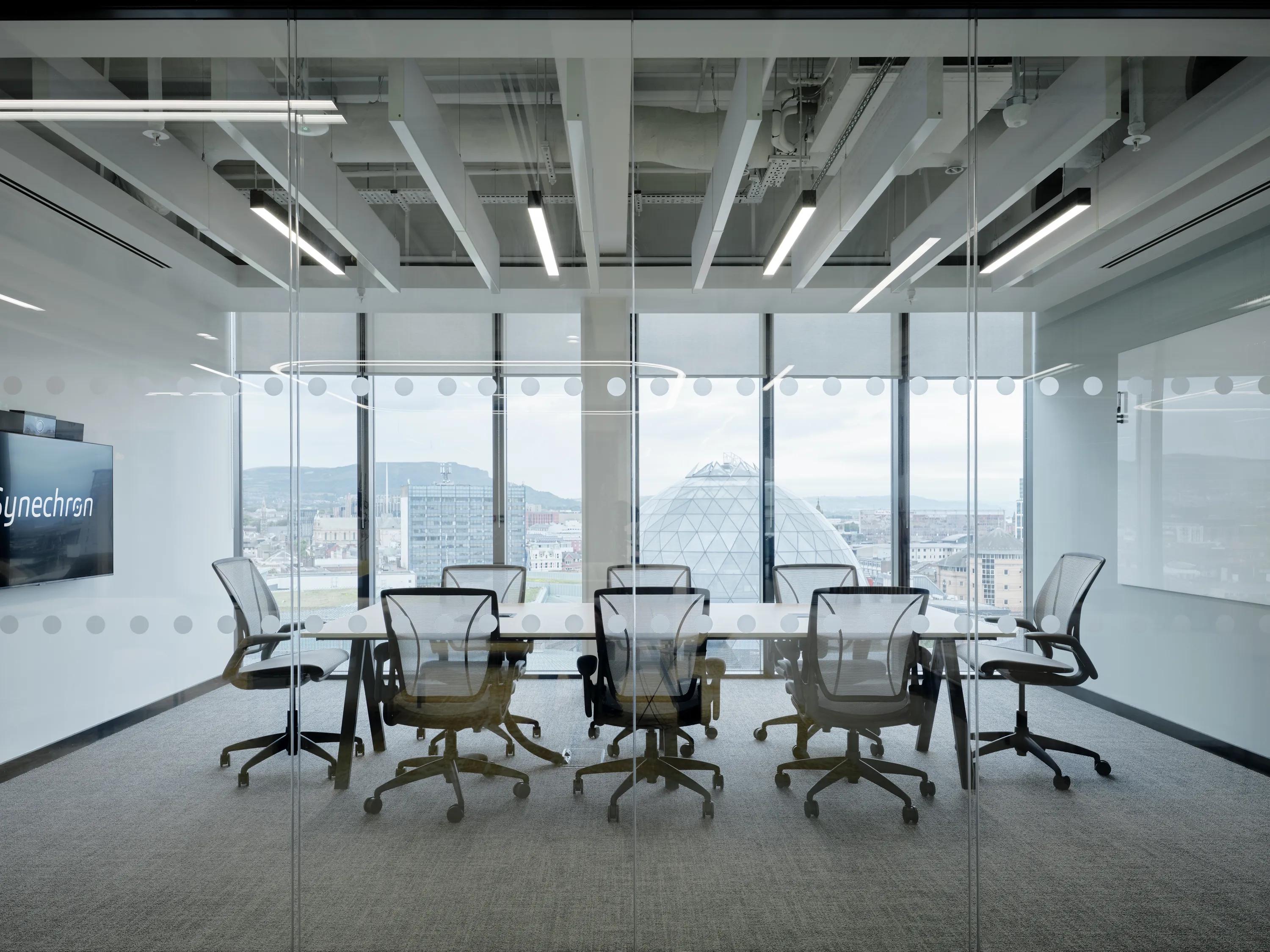 Synechron meeting room design in Belfast Ireland with Rockfon Universal Baffle ceiling