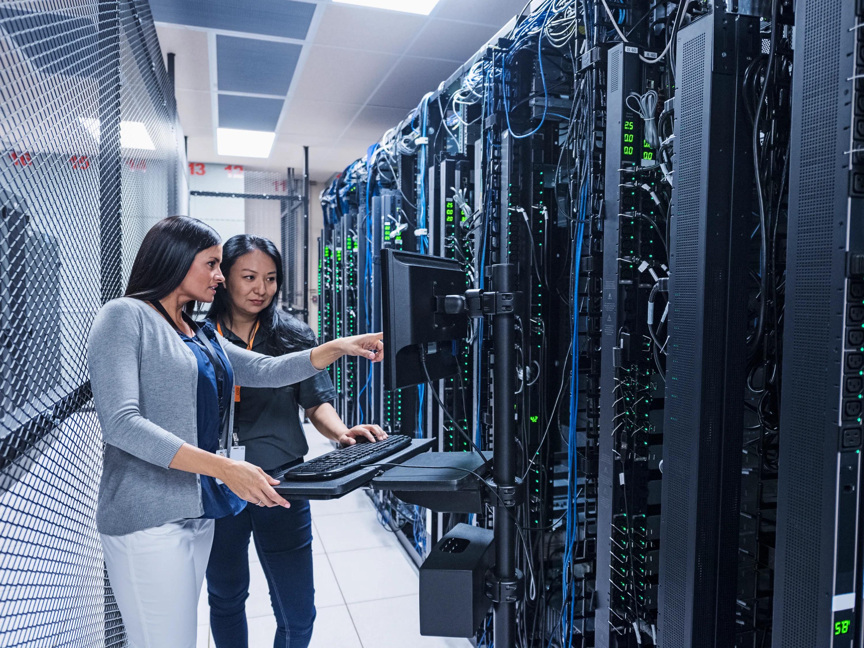 A data centre with optimised acoustics using sound insulation ceiling tiles and a ceiling grid.