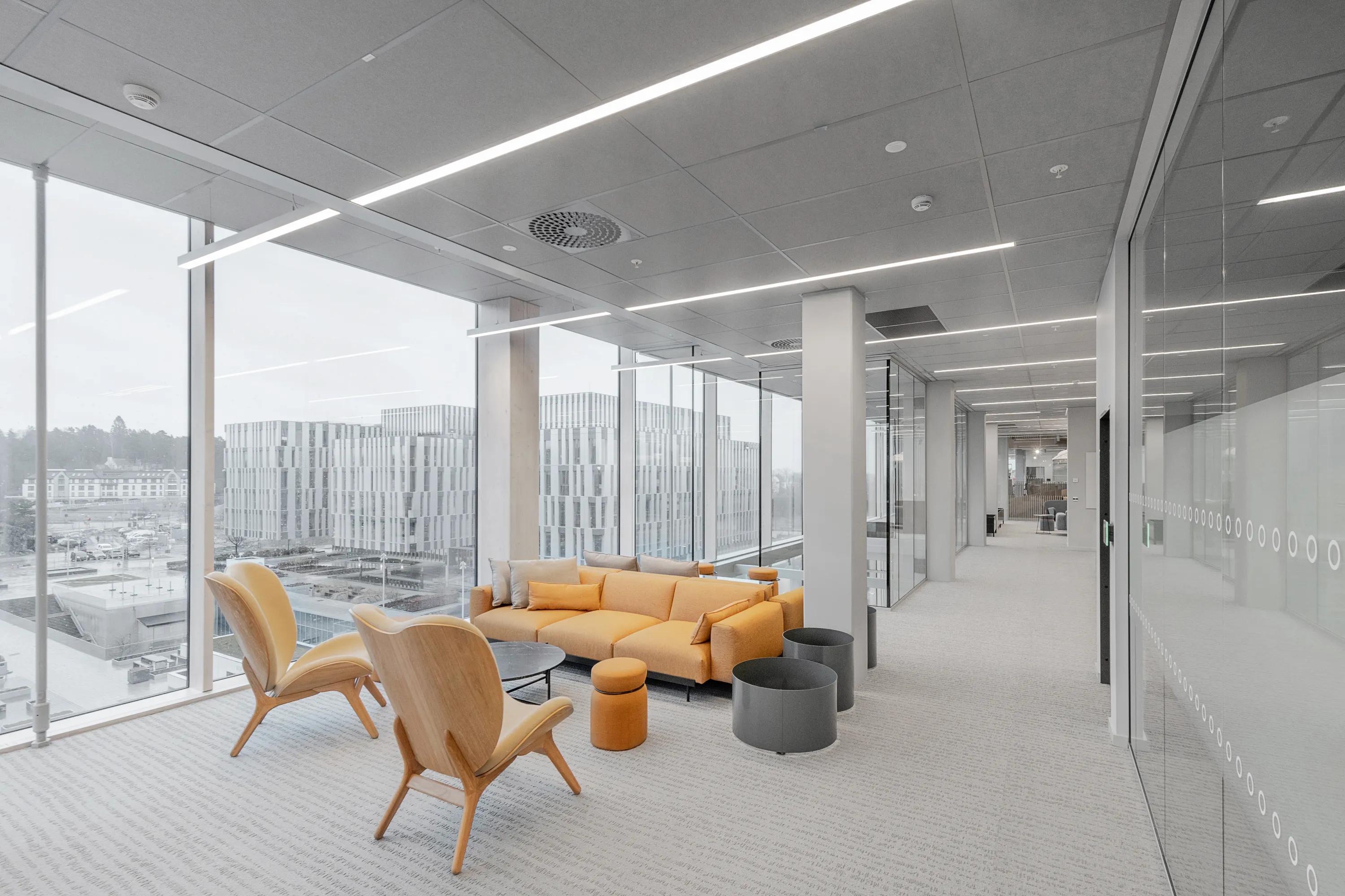 Grey ceiling tiles are an office breakout space