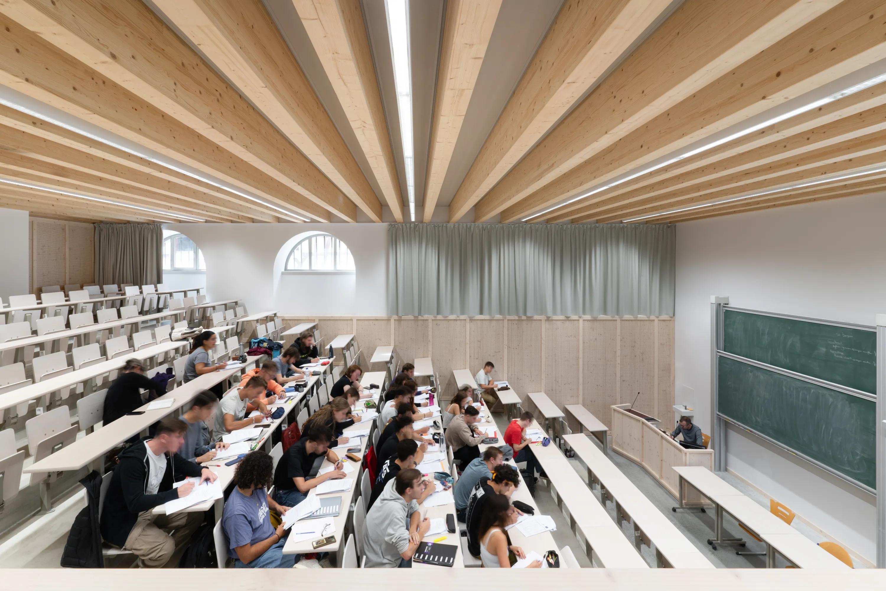 a lecture hall with an exposed beam open ceiling