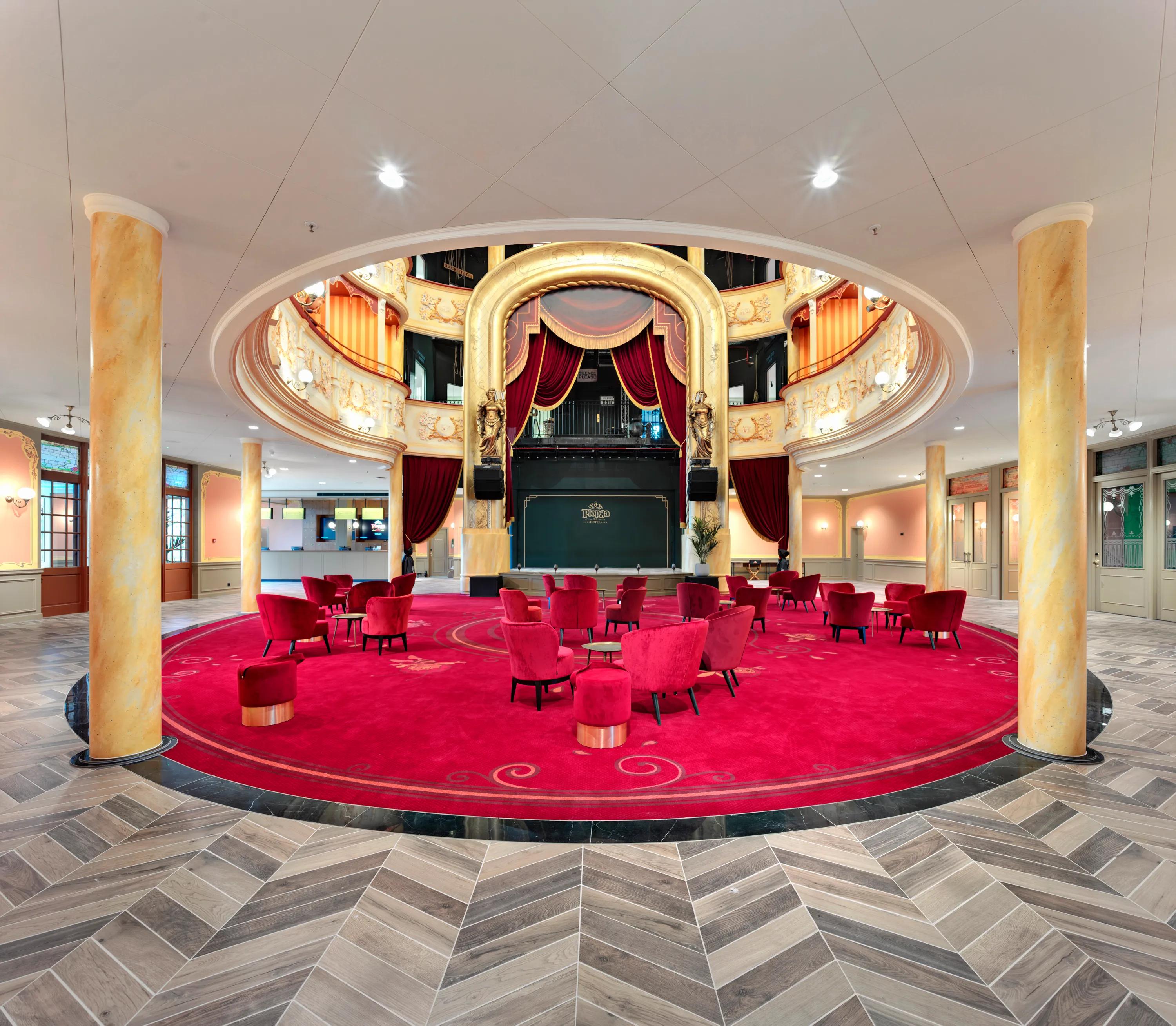 White hotel ceiling design at the auditorium and Lobby of Plopsa hotel in De Panne Belgium with Rockfon Color-all Stucco in D-edge