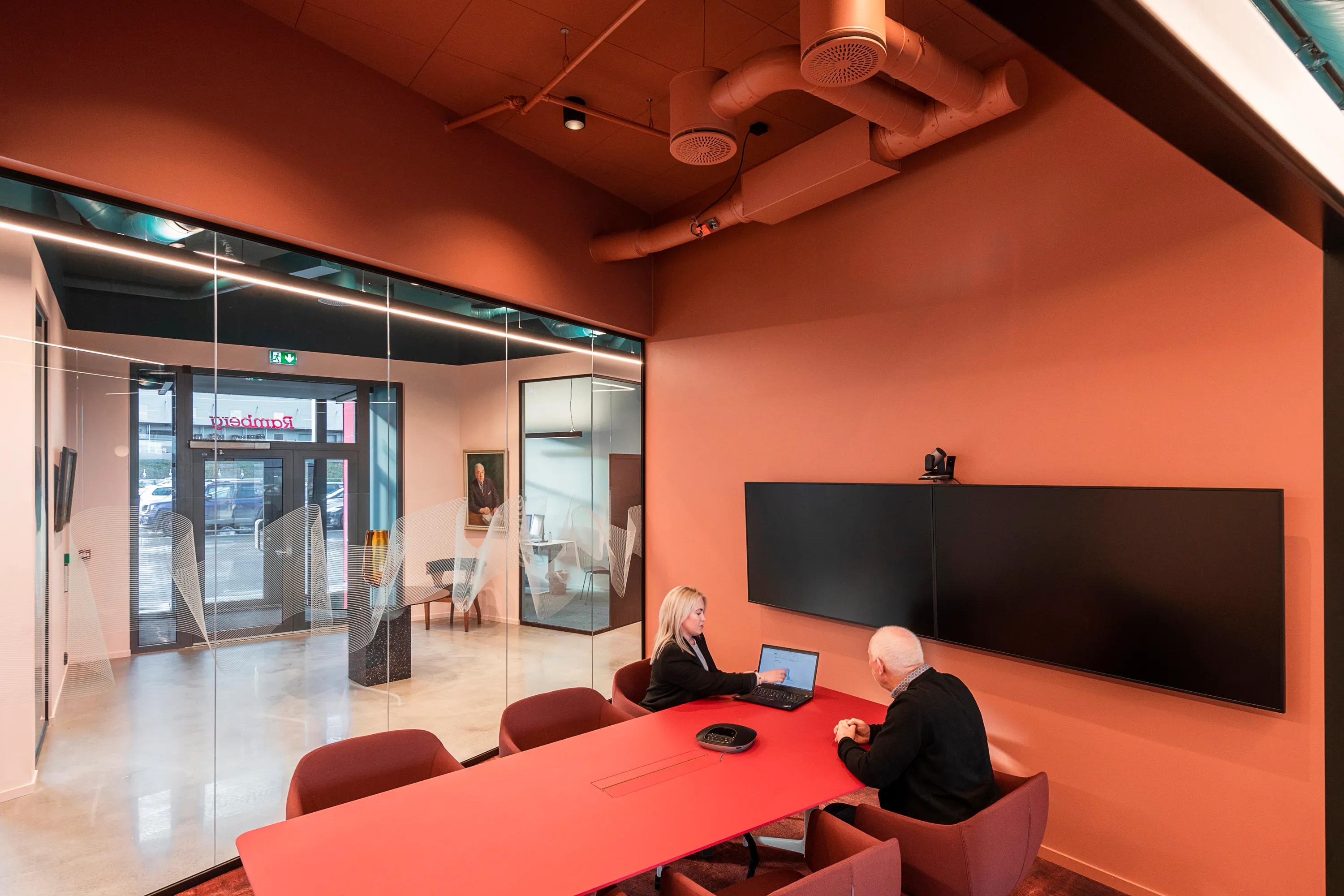 Meeting room in Ramberg Office with Rockfon Color-all salmon pink meeting room ceiling design