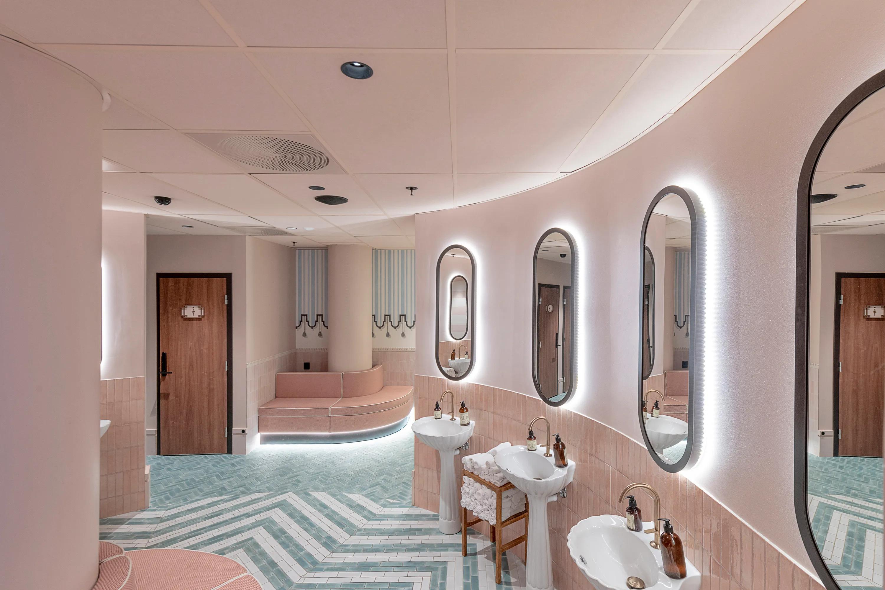 Colour-matched tile ceiling with pastel pink ceiling tiles and pink ceiling grid.