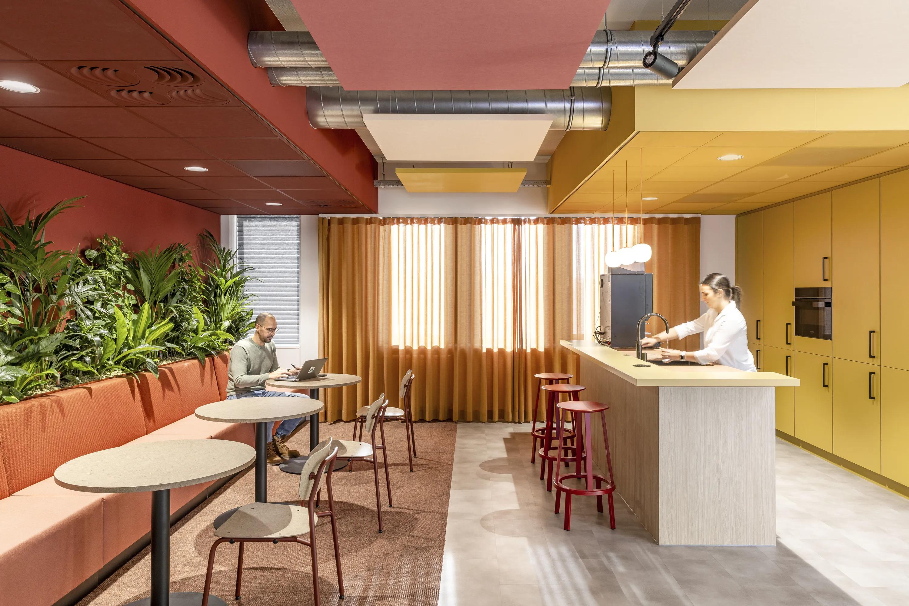 Hybrid plenum industrial acoustic pink and yellow ceiling design with exposed soffit and Rockfon Eclipse square floating ceiling panels.