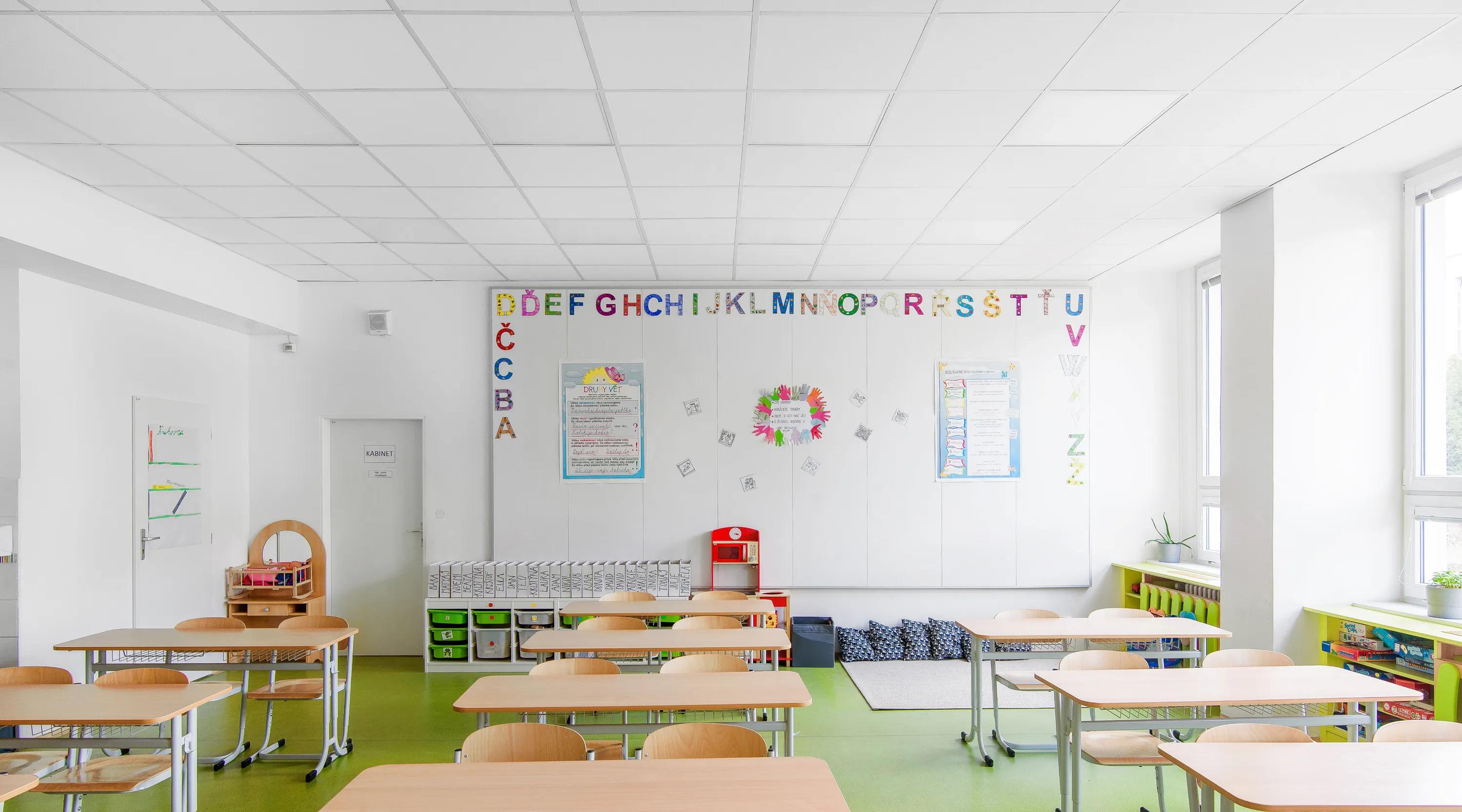 Bright school classroom with Rockfon white acoustic ceiling tiles and wall panels in renovated teaching spaces.