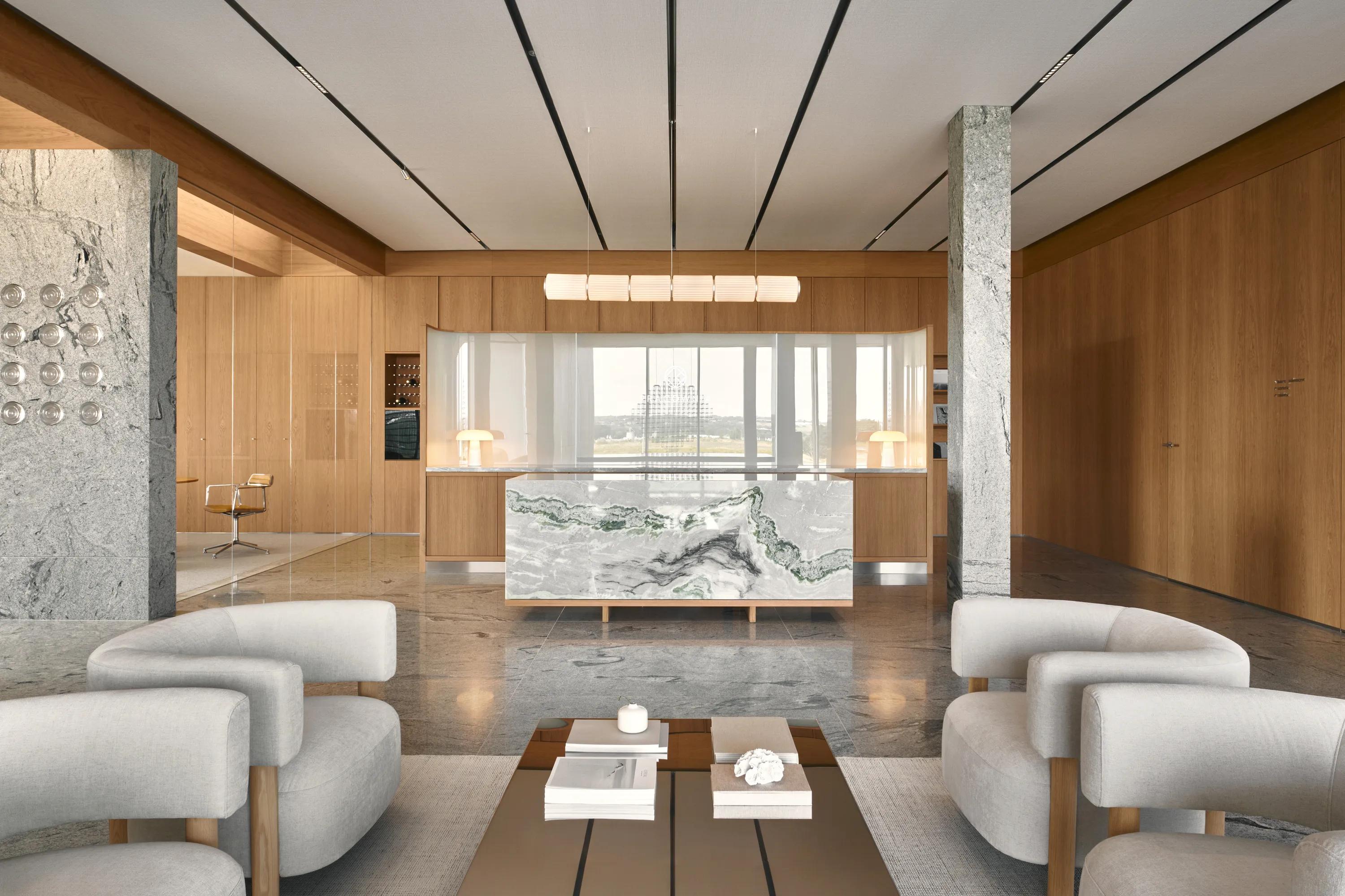 Detail view of Rockfon Blanka acoustic ceiling tiles in the office design of Omni Kaiser Patisserie Headquarters with wooden panelled walls. 