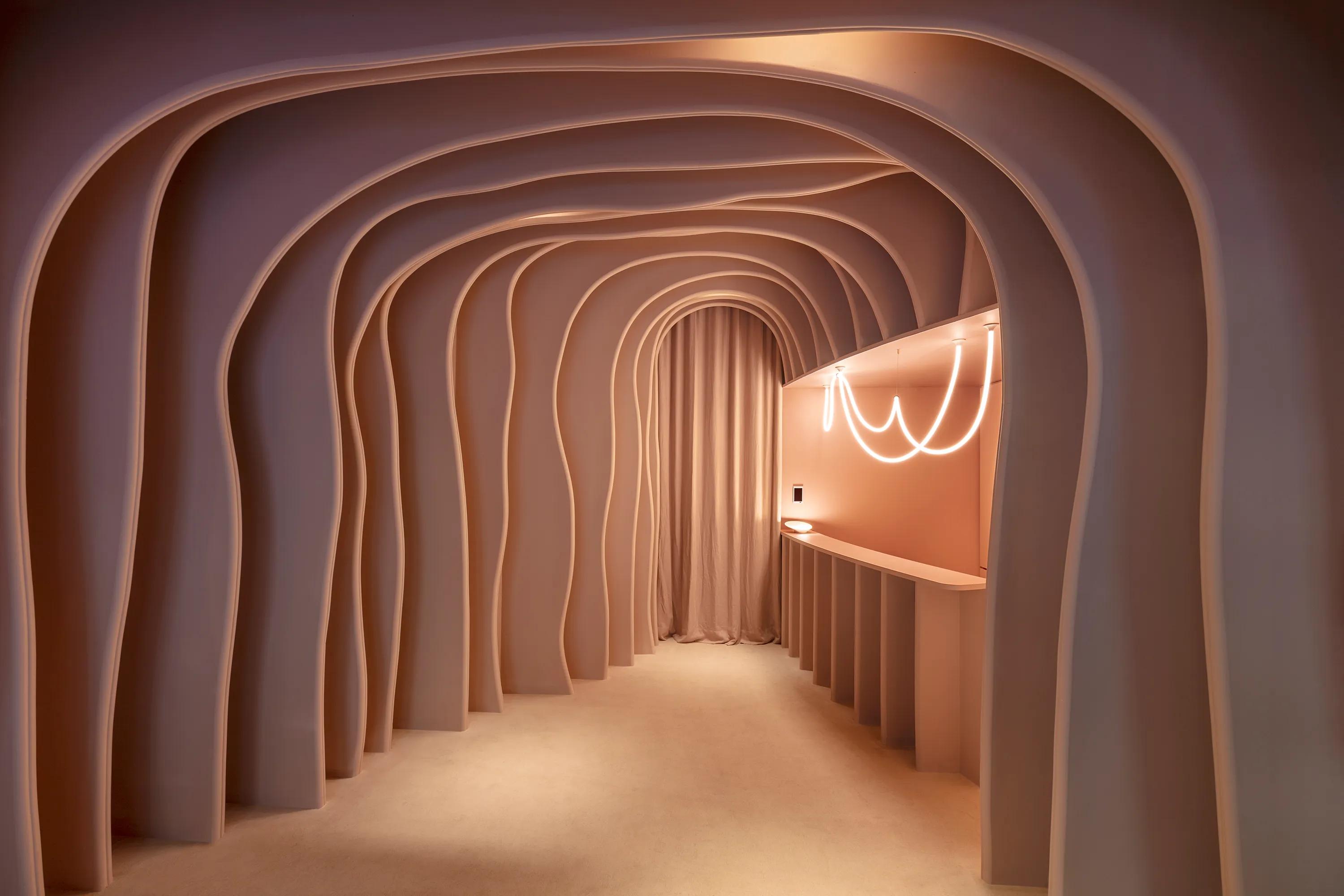 A decorative sculptural ceiling achieved using Rockfon Mono Acoustic in a salmon pink colour