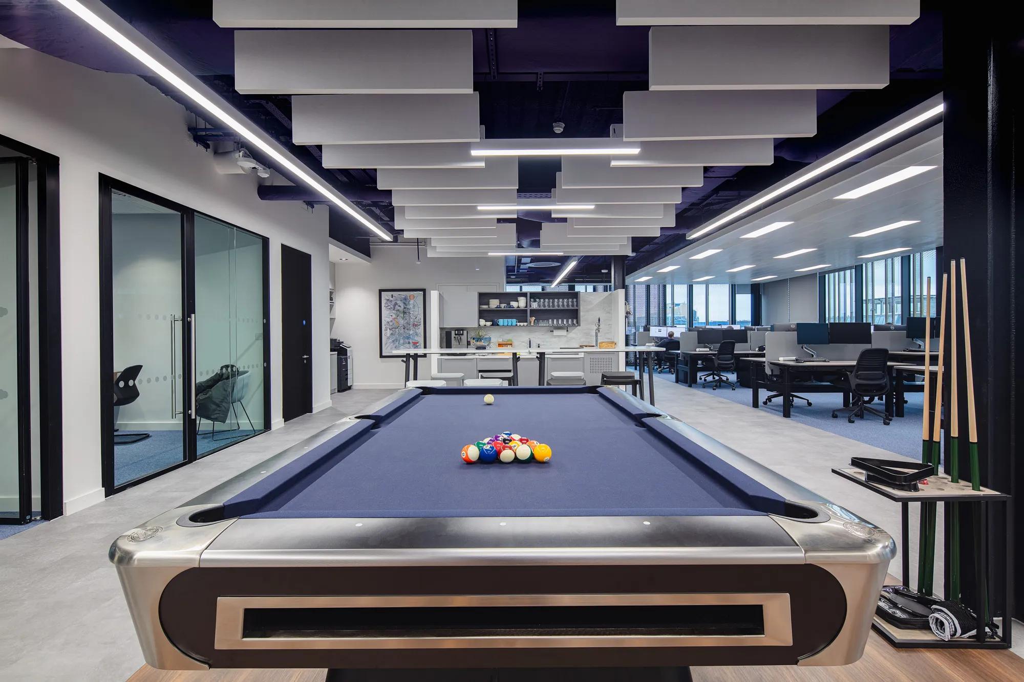 Room with blue billiards table in ACS Dublin offices in Ireland with a Rockfon baffle ceiling