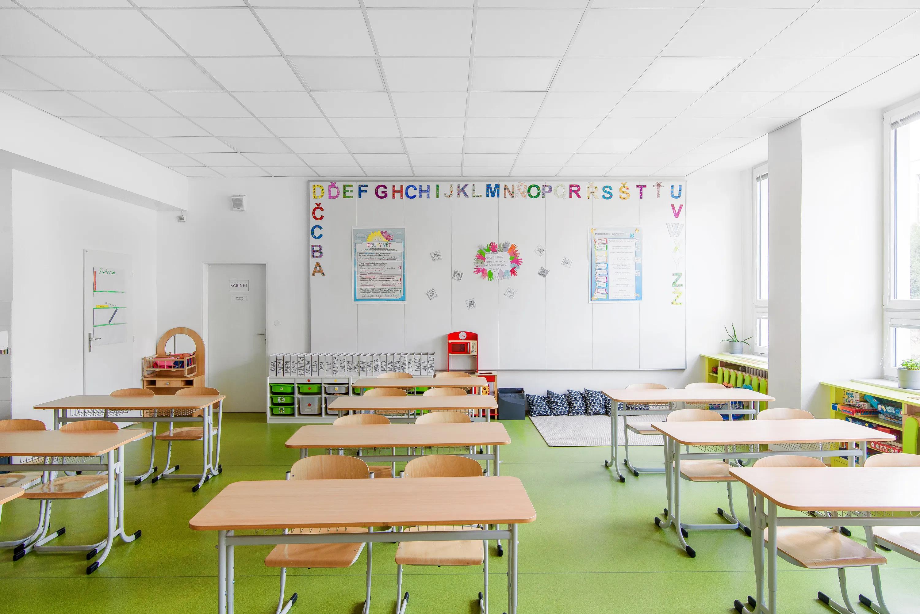 Bright school classroom with Rockfon white acoustic ceiling tiles and wall panels in renovated teaching spaces.